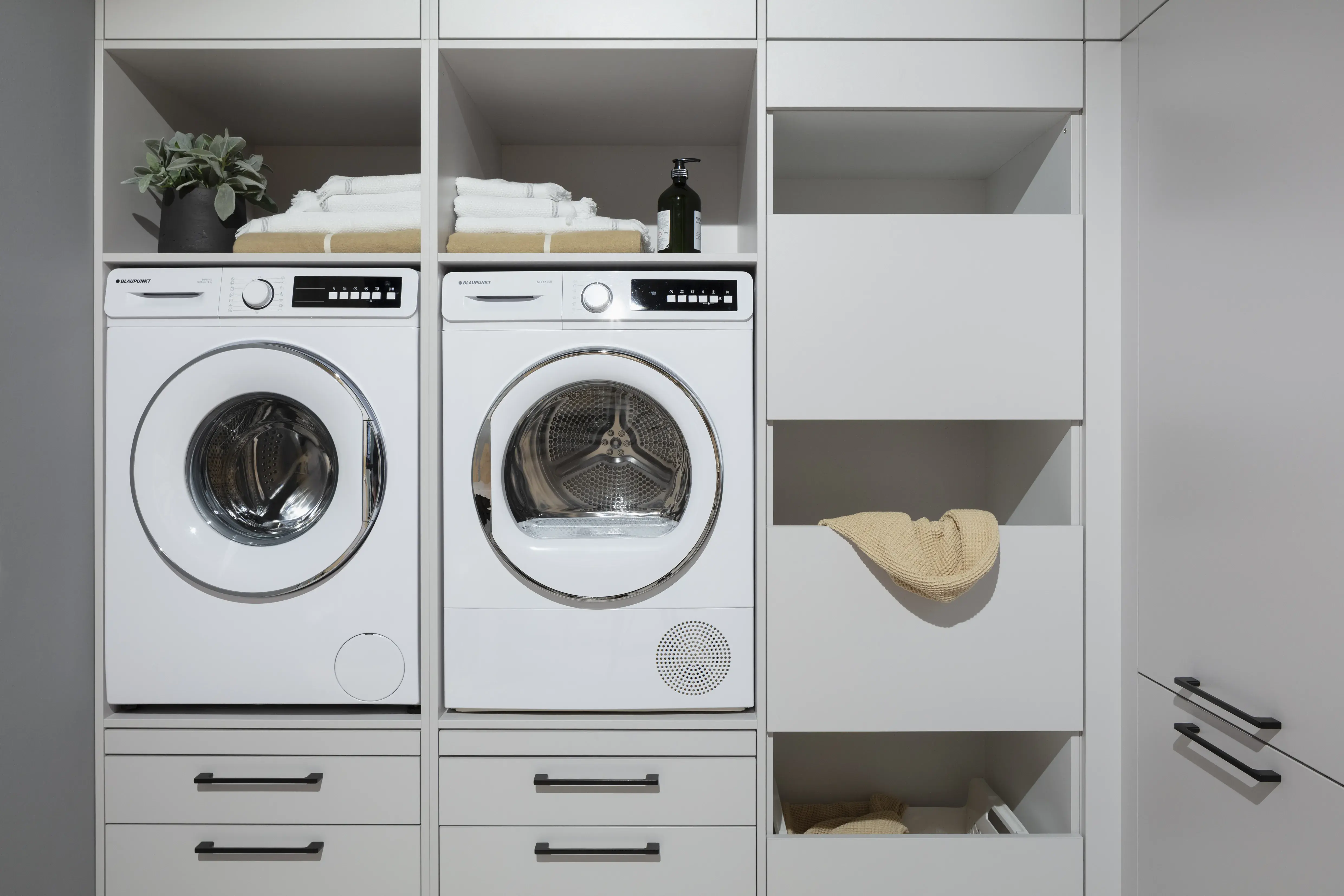 Hauswirtschaftraum mit Waschmaschine und Trockner von Blaupunkt. 